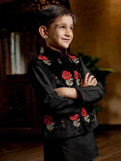 Stealing hearts and the spotlight. Our black velvet Bundi jacket with hand-embroidered red roses offers a bold contrast, creating a look that is both classic and striking.