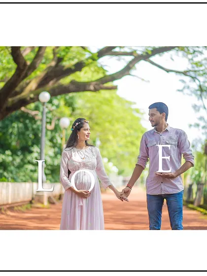 A creative photo using "LOVE" props, with the 'O' perfectly framing the baby bump.