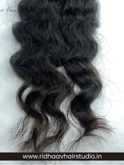 The beautiful, unprocessed texture of our raw curly I-Tip extensions, perfect for blending with naturally curly hair.