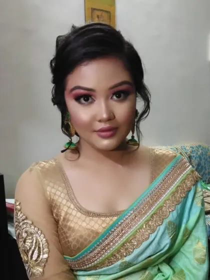A colorful and creative party look. The eye makeup uses a blend of pink, green, and silver, perfect for someone who loves to experiment.