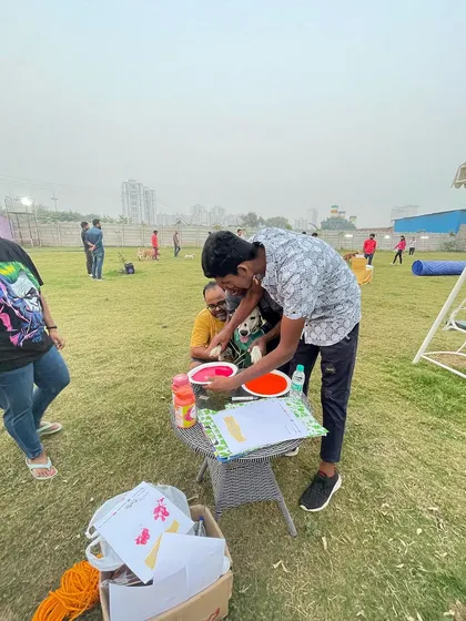 A staff member helping a guest and their furry friend make the perfect paw print. We're always on hand to help with activities.