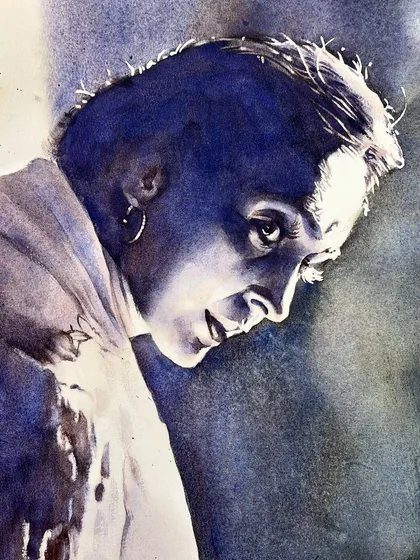 A dramatic monochrome portrait of actress Nutan, focusing on strong contrast and rim lighting.