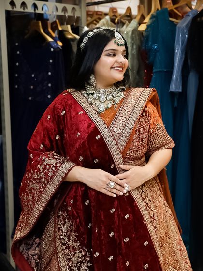 The joy of finding 'the one'. This bride-to-be is glowing in a luxurious red and orange velvet lehenga, a perfect choice for a winter wedding.