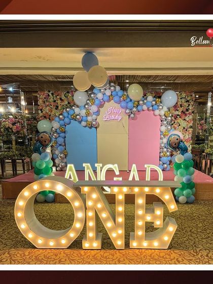 A front-facing view of Angad's spectacular first birthday stage, highlighting the large light-up 'ONE' marquee letters that serve as a fantastic centerpiece and photo opportunity.
