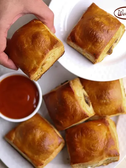 This is one of our most iconic snacks, the classic savory puff. Each one has a golden, flaky pastry shell that gives way to a delicious, warm filling. It's the perfect companion for your shaam ki chai or a quick bite on the go.