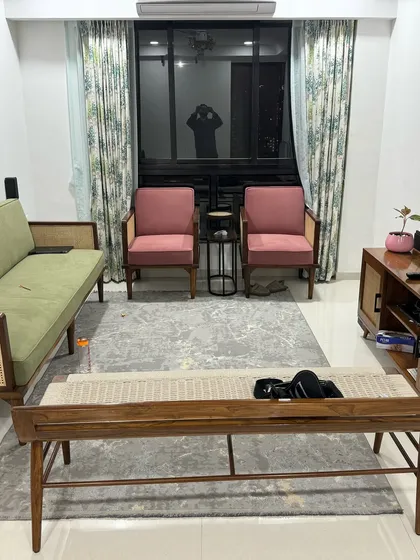 A full view of a client's living room, featuring my custom-made mid-century furniture. The set includes a sofa and two armchairs with cane details, a slatted-front media console, and a woven-top coffee table, creating a harmonious and stylish look.