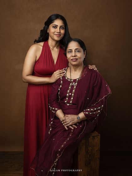 A classic seated portrait of a mother and daughter. Their poised and elegant pose creates a timeless piece of fine art.