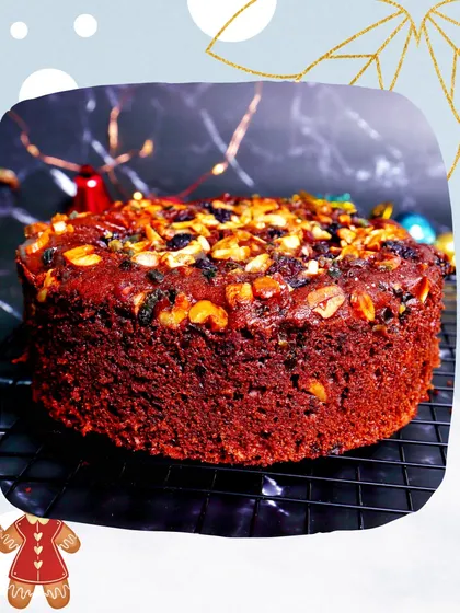 My eggless and alcohol-free Christmas plum cake, shown here in a festive setting. It's ready for delivery, baked fresh to bring warmth and sweetness to your holiday table.