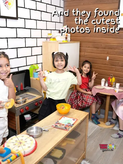Welcome to our little cafe. These girls are having a great time in the pretend play area, complete with a kitchen, grill, and dining table for endless imaginative fun.