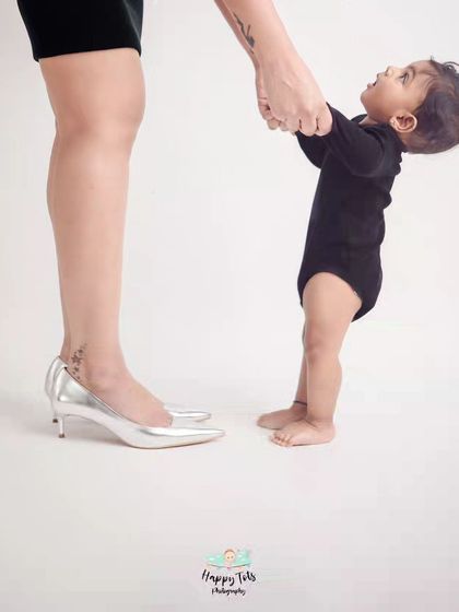 A baby looking up at his mother, holding her hand. This simple, minimalist photo powerfully captures a baby's trust and a mother's guidance.