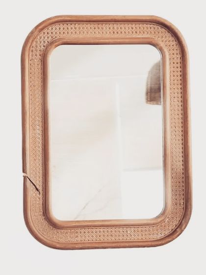 Our rectangular mirror is framed with beautifully woven cane, adding texture and warmth to the design. This piece is perfect for an entryway, bathroom, or bedroom, blending seamlessly with a variety of decor styles.