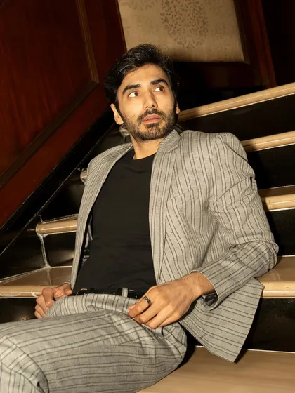 This candid-style shot for GQ captures an off-guard moment, adding authenticity and a narrative quality to the series.