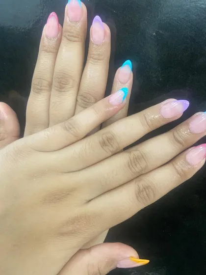 Have some fun with your nails. This is a playful take on the French manicure, with each nail tip painted in a different vibrant pastel color. It’s a great way to add a pop of personality to your look.