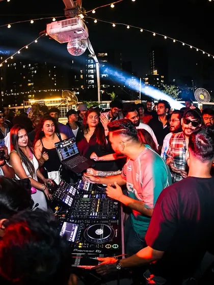 The crowd surrounding the DJ booth at the Block Party. The energy is tangible when you're this close to the action.