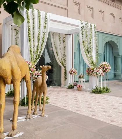 Camel statues at the entrance, adding a touch of Rajasthani charm and character to the welcome decor.