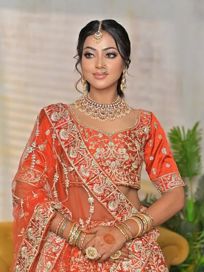 A confident pose showing the complete bridal ensemble. The Kundan jewellery shines, proving it's the centerpiece that transforms the bride.