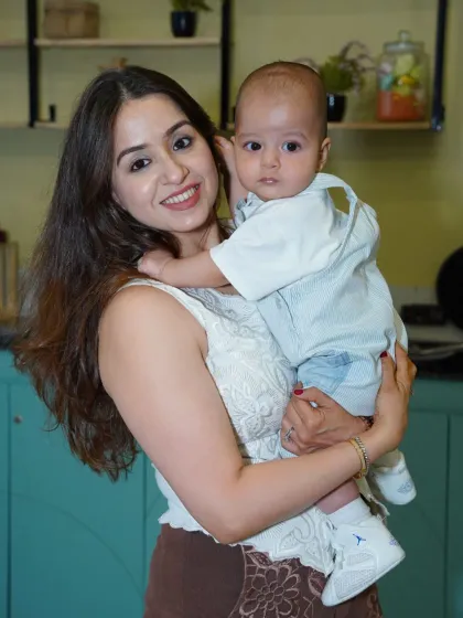 A mother holds her baby, showing that even the youngest members of the family are welcome at Wobble World. It's a safe and fun environment for all ages.