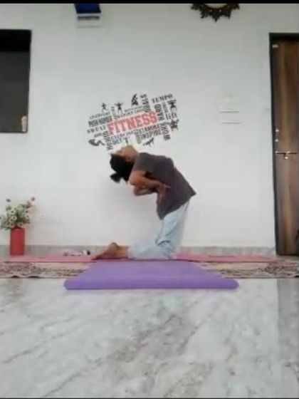 An instructor demonstrates a supported Ustrasana (Camel Pose) during an online class. We emphasize safe practice by showing how to use props and modifications to achieve poses without strain.