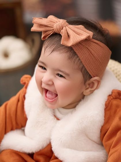 That pure, open-mouthed laugh is what we live for. This close-up portrait captures a moment of absolute joy during a sitter session.