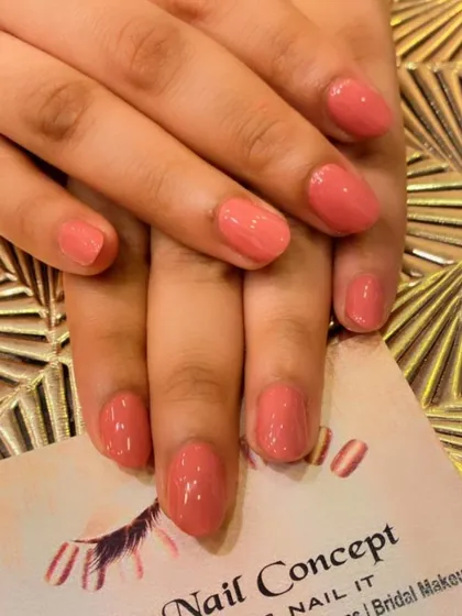 A simple and pretty set of short, natural nails in a peachy-pink color. This is a great option for a low-maintenance, polished look.