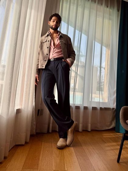 The full-length view of Siddhant's outfit. The wide-leg trousers and casual jacket create a relaxed yet polished silhouette.