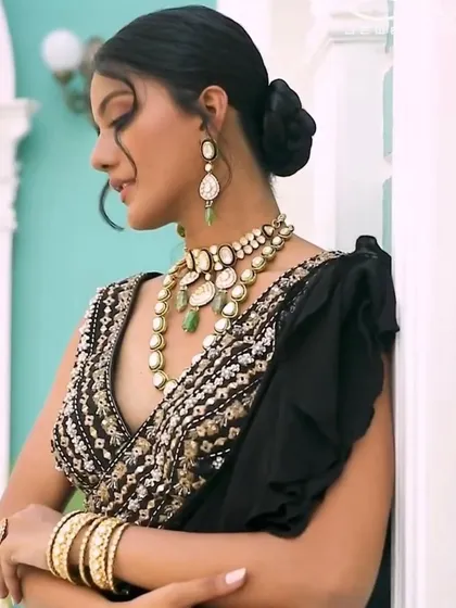 A side profile showcasing the elegant polki set and how it complements the embroidered blouse and ruffled saree. This look is all about modern elegance, perfect for a cocktail party or sangeet.