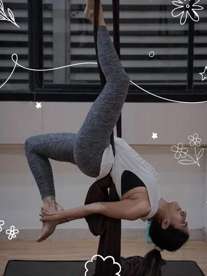 Discover a unique blend of strength and artistry in our aerial silk workshops. This participant showcases the beautiful shapes you can create while suspended, building confidence with every move.
