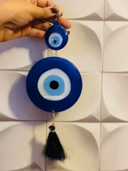 A large evil eye wall hanging, designed to protect your space with style.