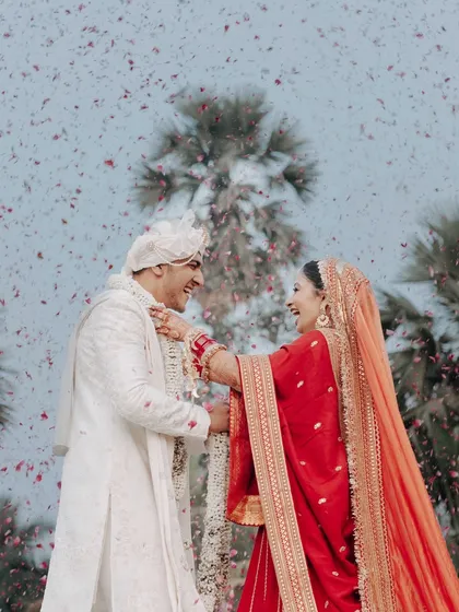 This is the kind of pure, unscripted joy we live to create. A candid varmala moment captured under a shower of rose petals, celebrating a love that's real and beautiful.