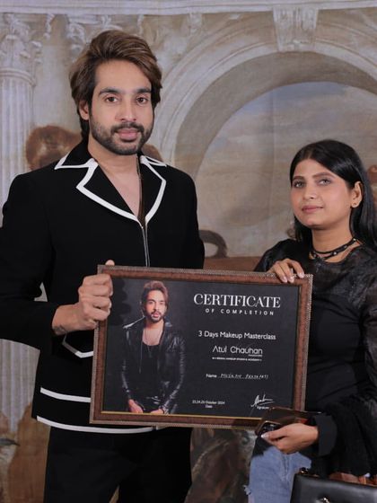 Awarding a certificate to another successful student. Her passion for makeup was evident throughout the course.