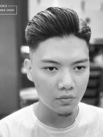 A frontal view of a classic pompadour fade. We use quality styling products to create hold and volume that lasts all day.