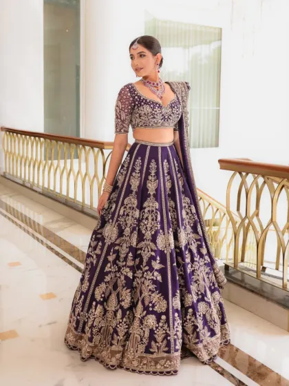 Another angle of this regal purple lehenga, showcasing its beautiful drape and the way the embroidery catches the light. It’s a perfect example of how I help brides find outfits that make them feel like royalty.