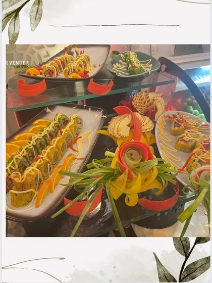 An artistic display of various sushi rolls on a multi-level glass stand, showcasing the variety and creativity of our sushi chefs.