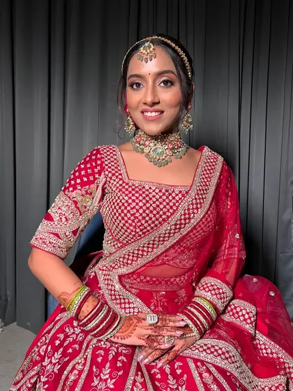 A full portrait of Apurva, showcasing her complete bridal look from head to toe.