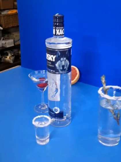 A raw, unedited look at our blue-themed vodka shoot, showing the products and props before the final lighting and retouching.