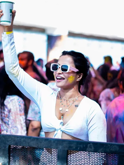 A guest raising a glass to the celebration at our High Ultra Lounge Holi party. We ensure a great selection of beverages to keep the party going.