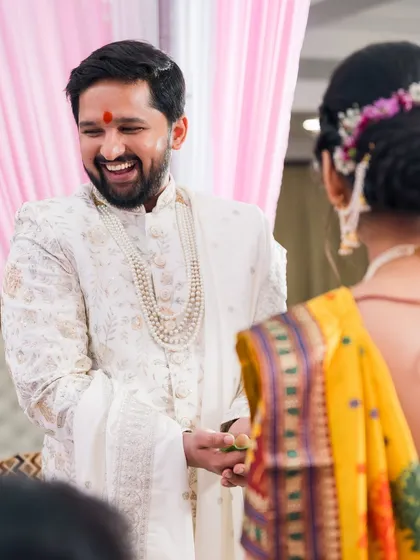 The groom's face lights up with a huge smile as he sees his bride. This is the 'first look' moment we love to capture.