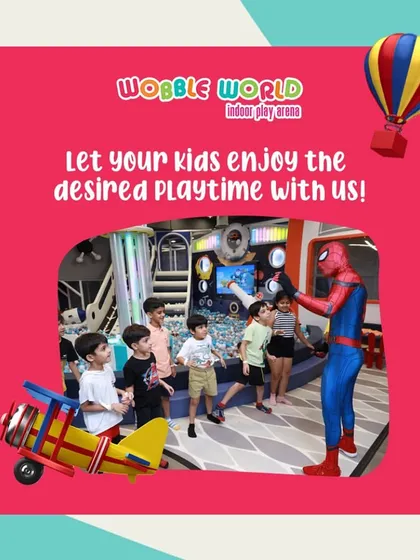 Kids gather around Spiderman in our play area. We provide the desired playtime experience with fun activities and special guests.