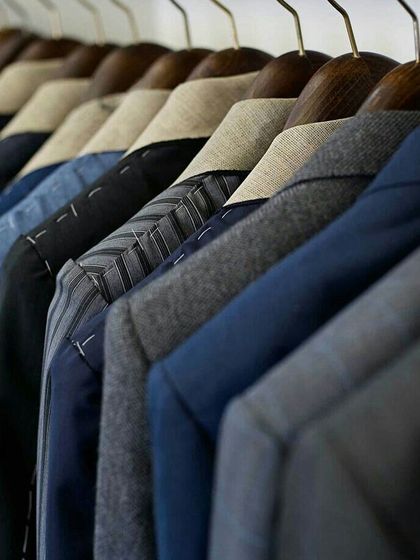 A rack of our bespoke creations in progress. Each piece is meticulously crafted, waiting to be delivered to a discerning client.