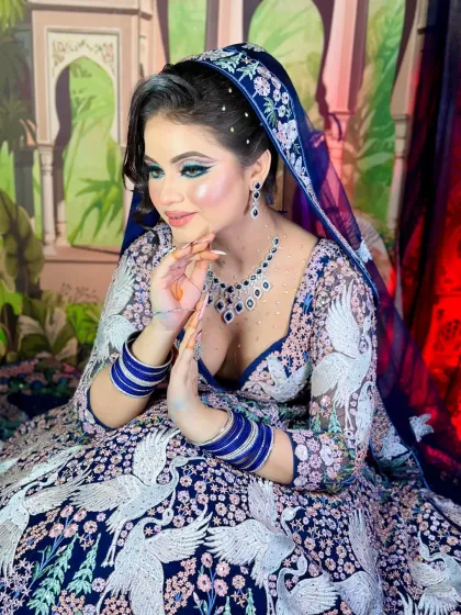 A full shot of the swan-inspired look. The blue lehenga with white swan embroidery is the inspiration for the dramatic eye makeup.