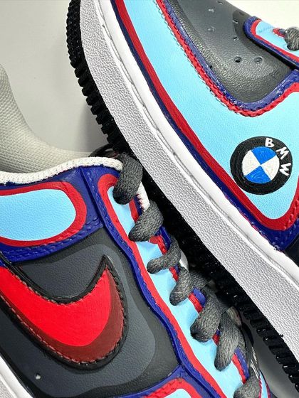 A close-up of the BMW custom AF1, showing the layered colors and the hand-painted logo.