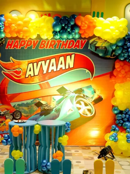 A close-up of the impressive Hot Wheels birthday backdrop, framed by a colorful balloon arch. It's the perfect centerpiece for a high-octane party.