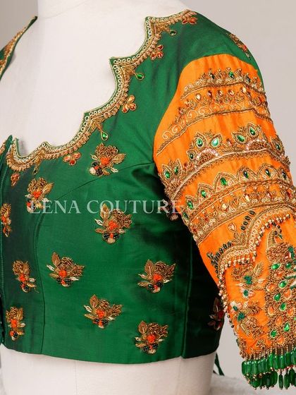 This blouse is a celebration of vibrant color and artistry. I used a rich green raw silk base and contrasted it with bright orange sleeves, which feature incredibly detailed peacock embroidery using zardozi, stones, and beadwork.