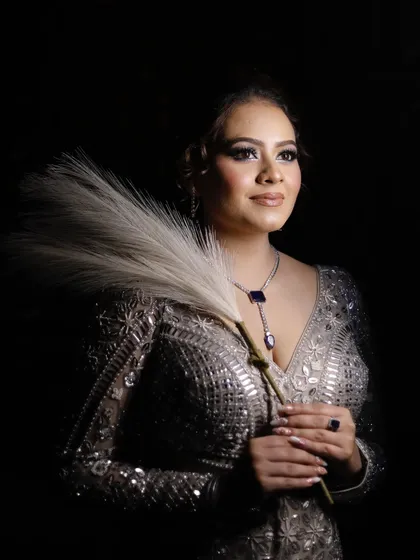 A glamorous portrait. The lighting beautifully captures the glow and shimmer of the makeup.