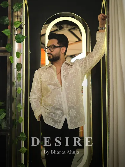 A confident pose in the sheer floral shirt, proving that transparency is the ultimate statement of self-assurance.