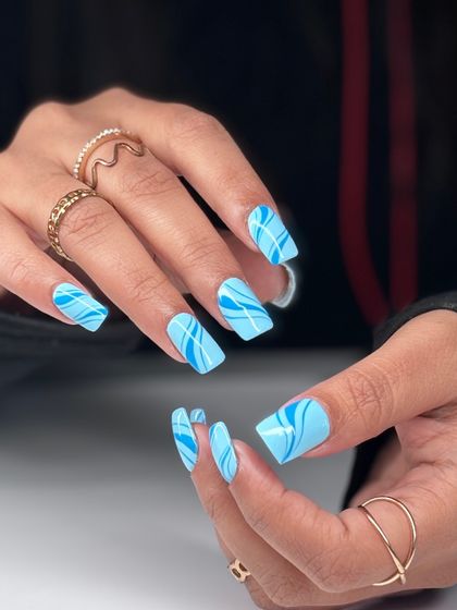 Another view of the blue swirl nail art. The clean lines and bold pattern make this a real statement manicure on square-shaped extensions.