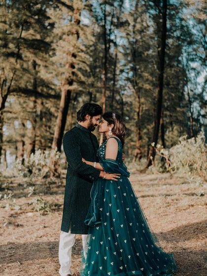 An intimate shot of the couple, highlighting their coordinated outfits in a natural, romantic setting.