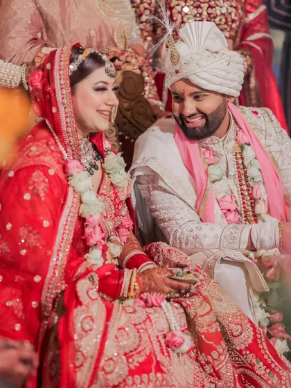 A candid shot of the couple sharing a lighthearted moment during the ceremony, surrounded by family. These are the unscripted memories that bring an album to life.