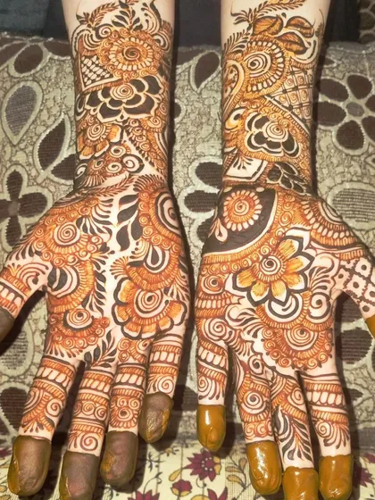 The palms of the floral design, showing how the theme continues with more intricate flower and leaf motifs. This is a perfect choice for a bride who loves floral henna.
