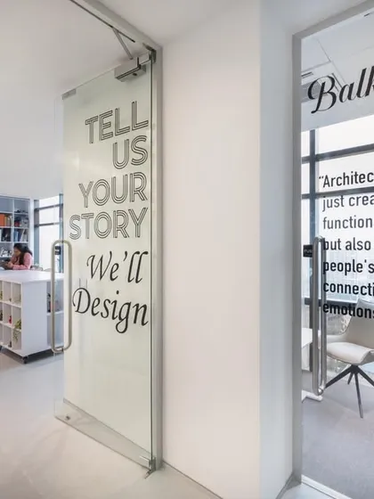 The entrance to our office, featuring our motto "Tell Us Your Story, We'll Design" and a quote from the legendary architect Balkrishna Doshi.